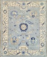 hand knotted Oushak rug in soft blue and ivory floral design
